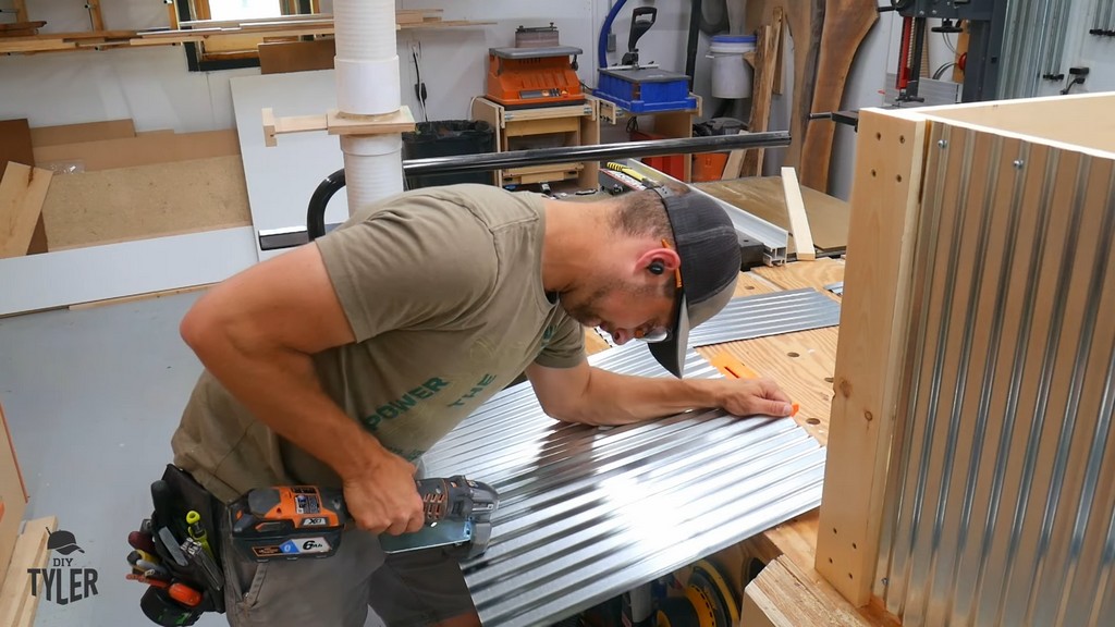 man cutting galvanized paneling with RIDGID tin-cutting tool