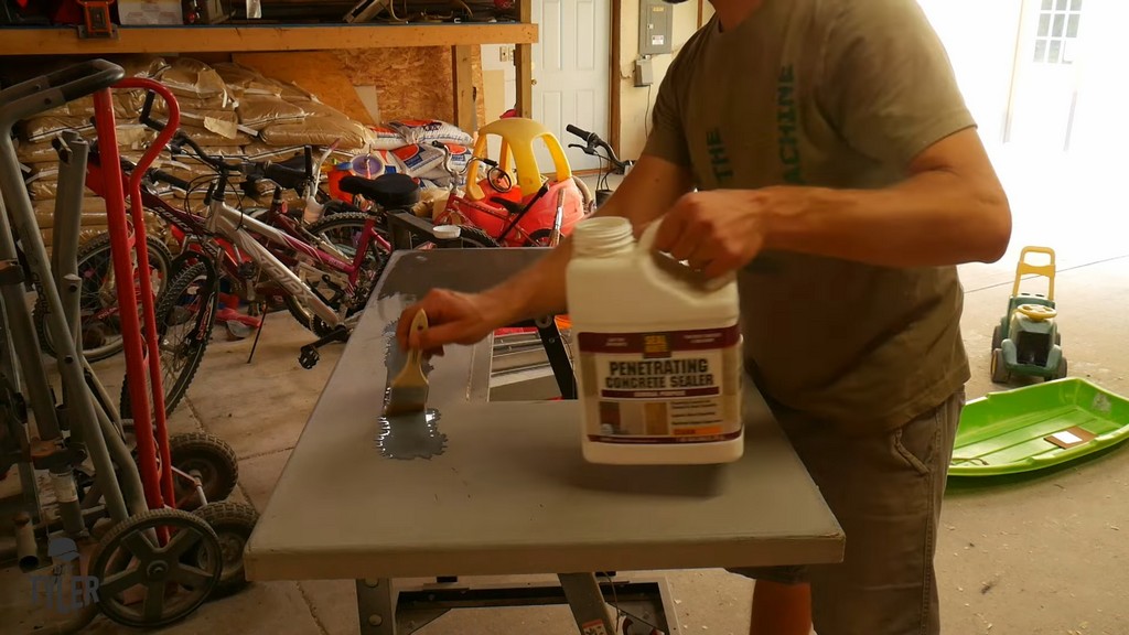 man applying Seal-Krete concrete sealer to DIY deck fire table slab