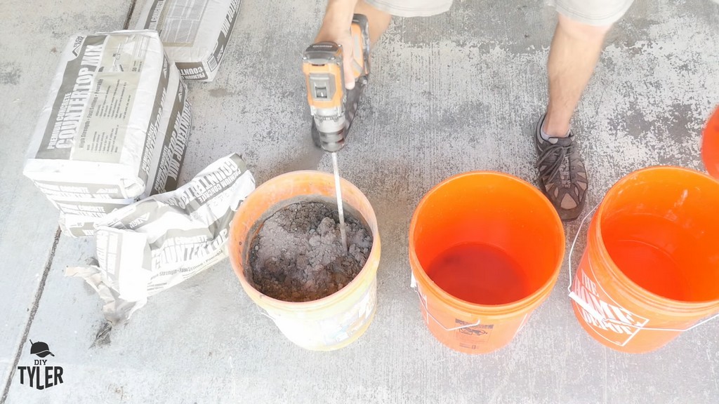 man mixing bucket of DIY concrete mix