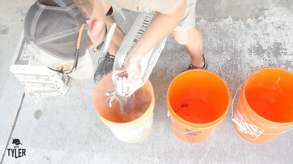 man pouring bag of DIY concrete mix into bucket of water