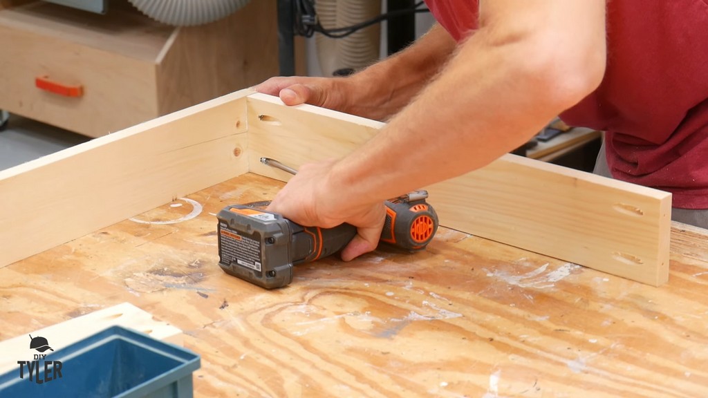 man drilling screw into pocket hole for table frame