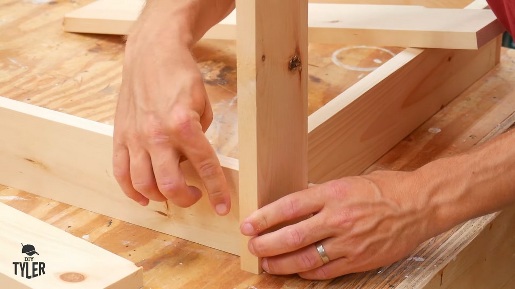 man demonstrating offset of table leg