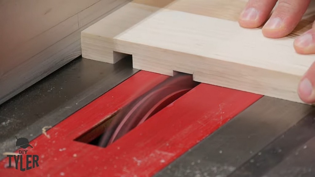 man cutting groove into board with dado blade