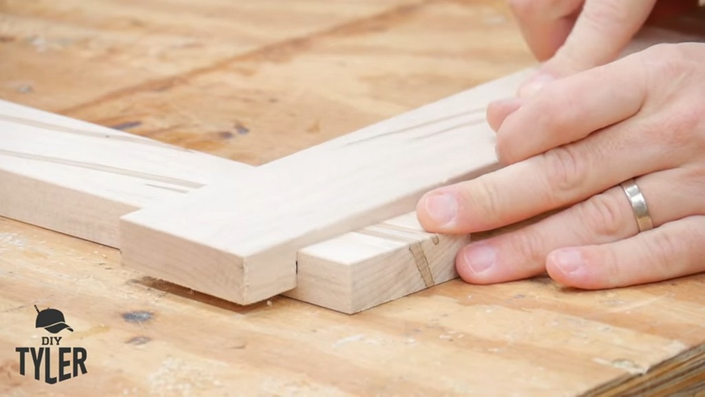 man fastening half-lap wood joint