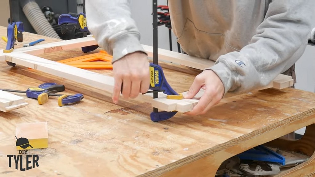 man clamping half-lap wood joint