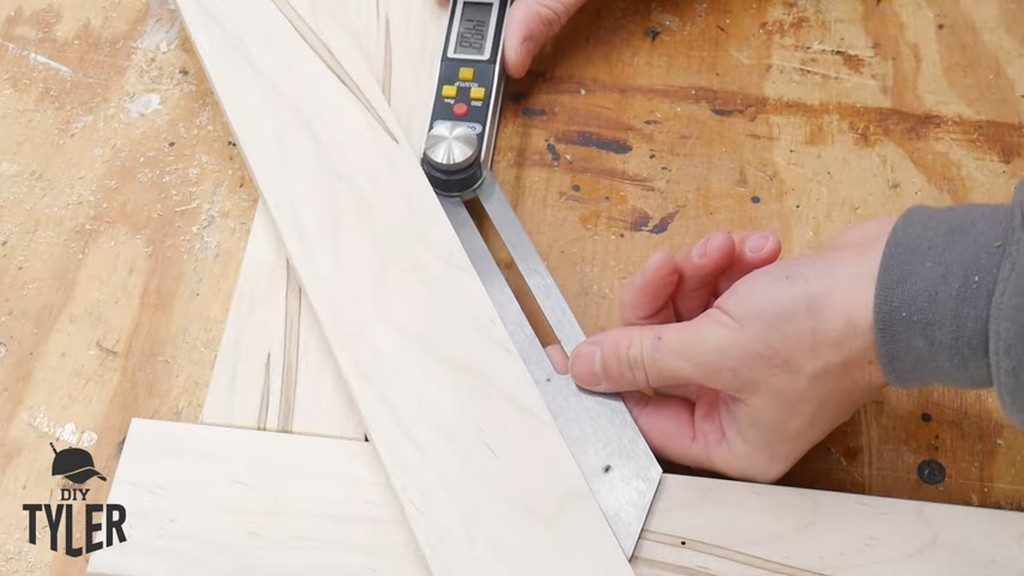 man measuring angle for corner piece of square picture frame