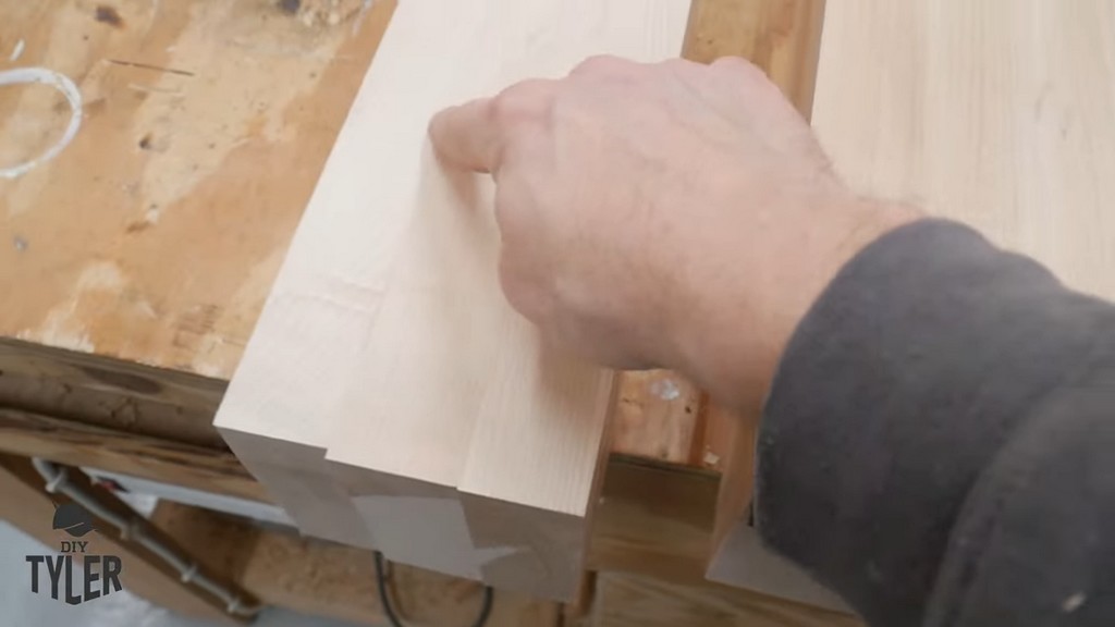 man pointing to laminated pieces of hard maple wood