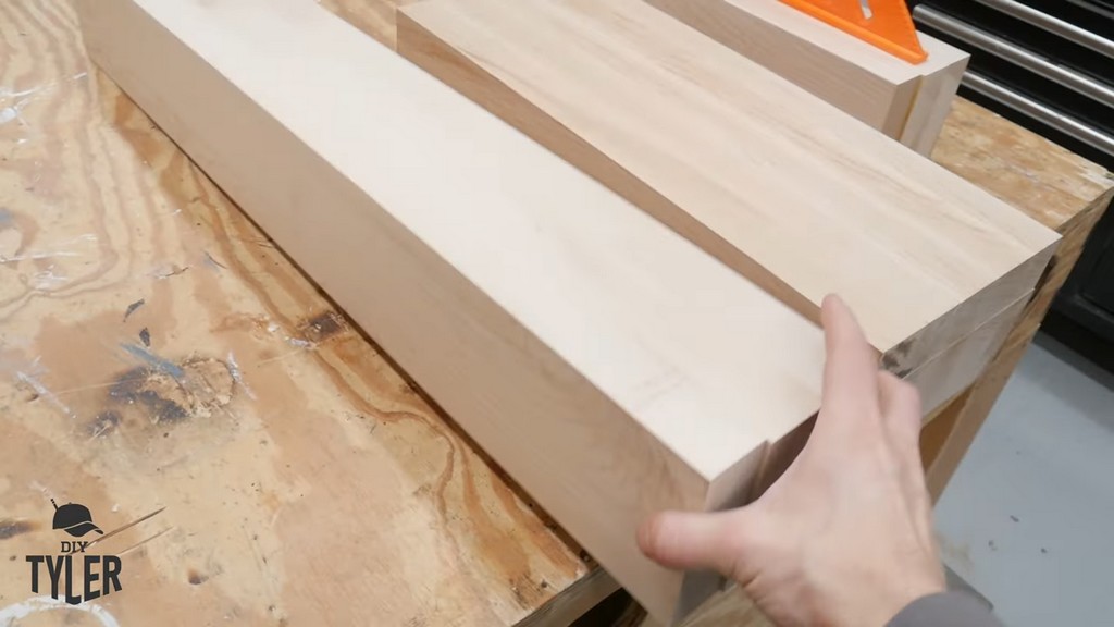 man holding up laminated pieces of hard maple wood