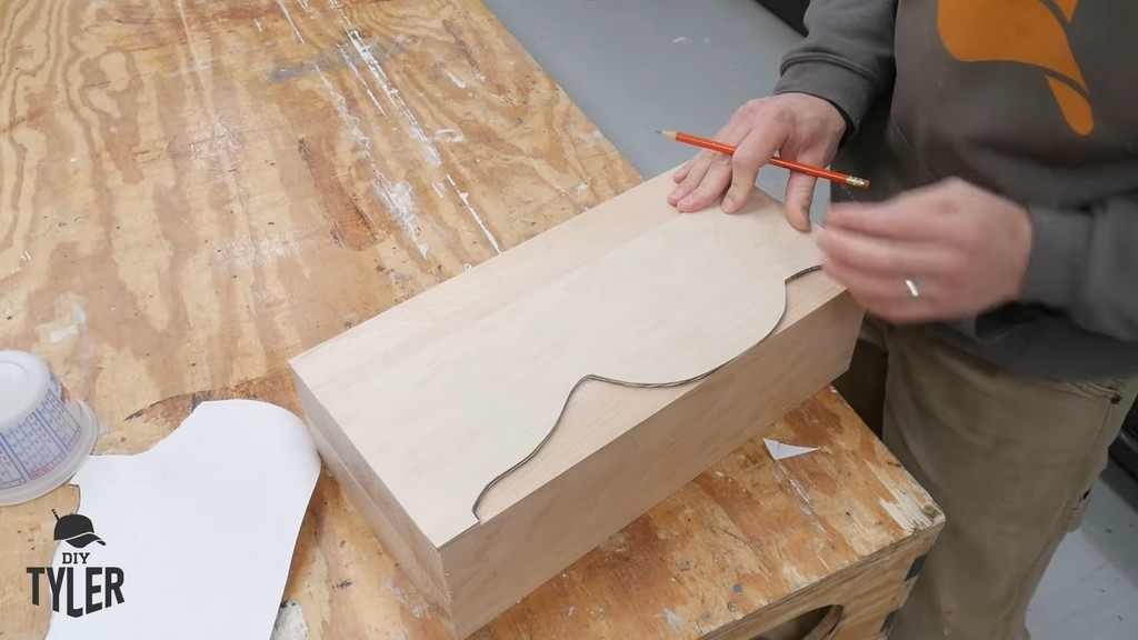 man using template to trace pedestal shape onto hard maple wood piece