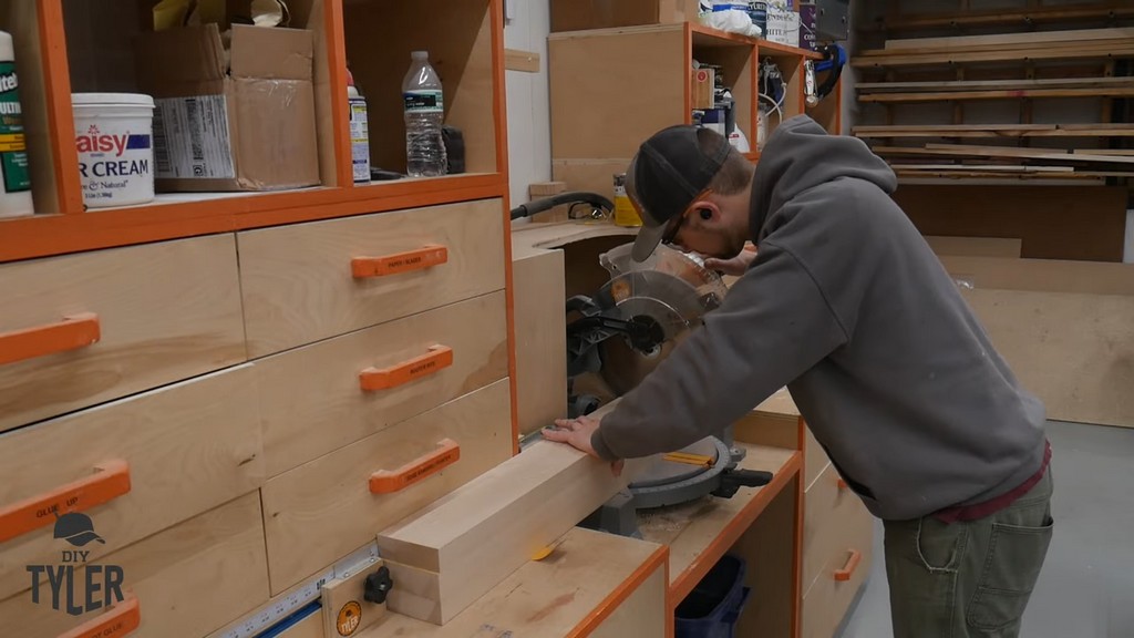 man cutting hard maple wood piece with miter saw