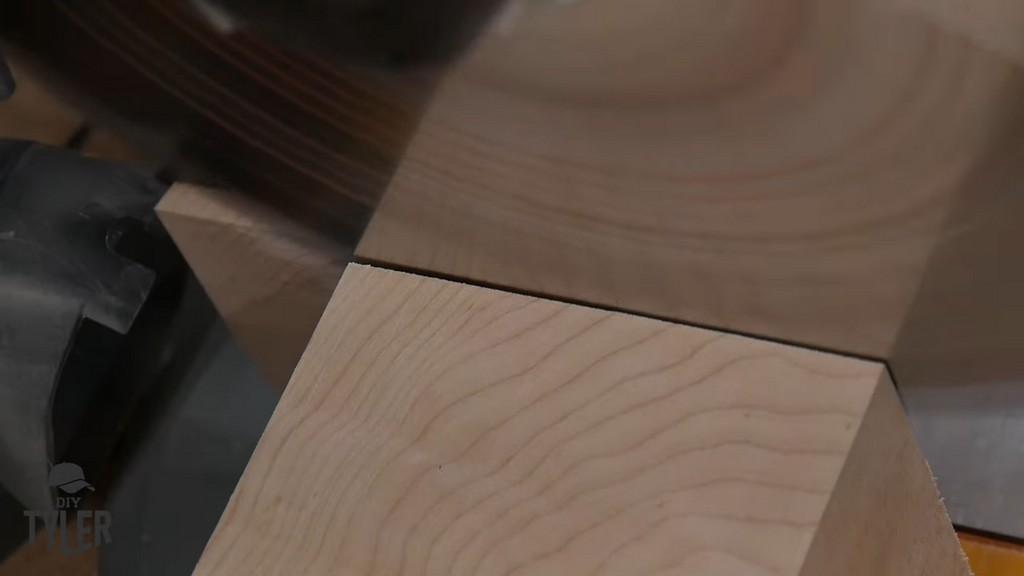 miter saw cutting through hard maple wood