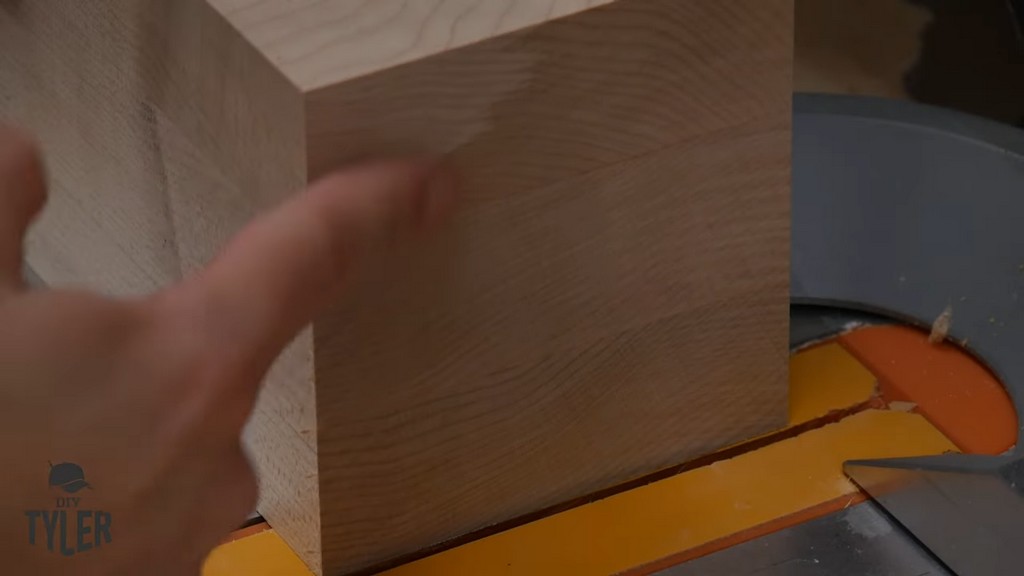 man pointing to recently cut hard maple wood piece