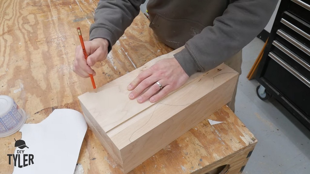 man using template to trace pedestal shape onto hard maple wood piece