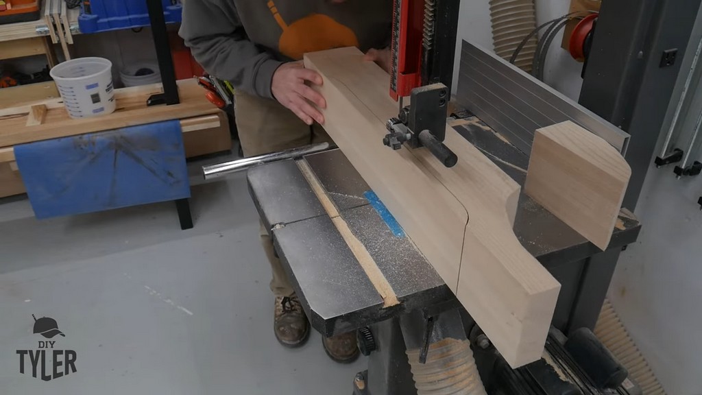 man running hard maple wood piece through bandsaw