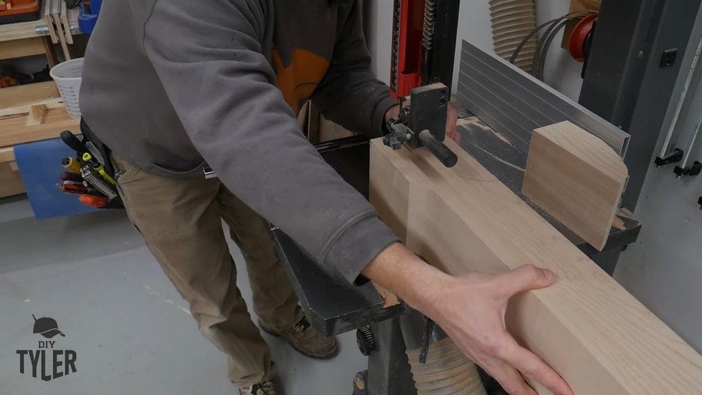 man running hard maple wood piece through bandsaw