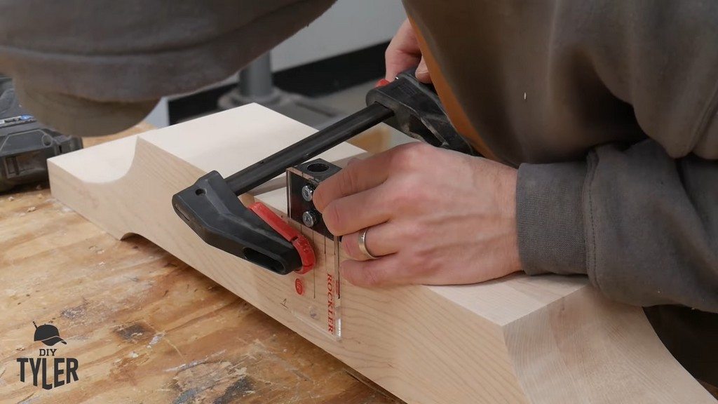 man clamping dowel jig for dowel holes in pedestal piece