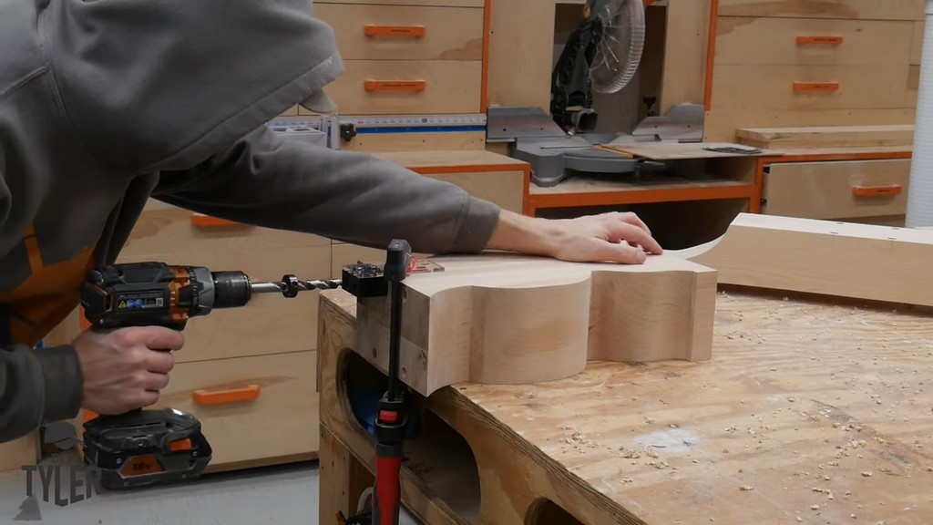 man drilling dowel holes into vertical pedestal piece