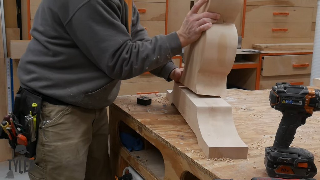 man putting vertical and base pedestal pieces together
