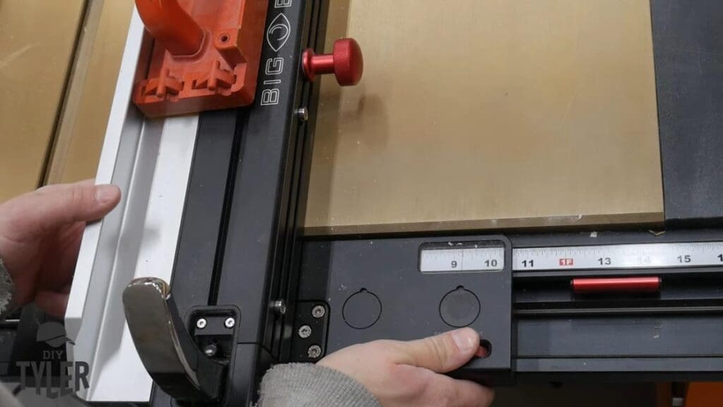 man cutting plywood at table saw