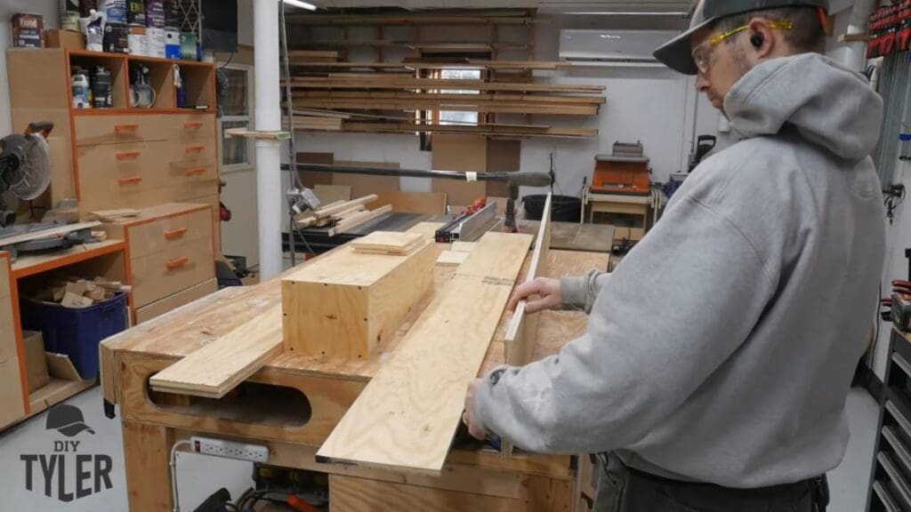 man preparing long wood pieces for steam box