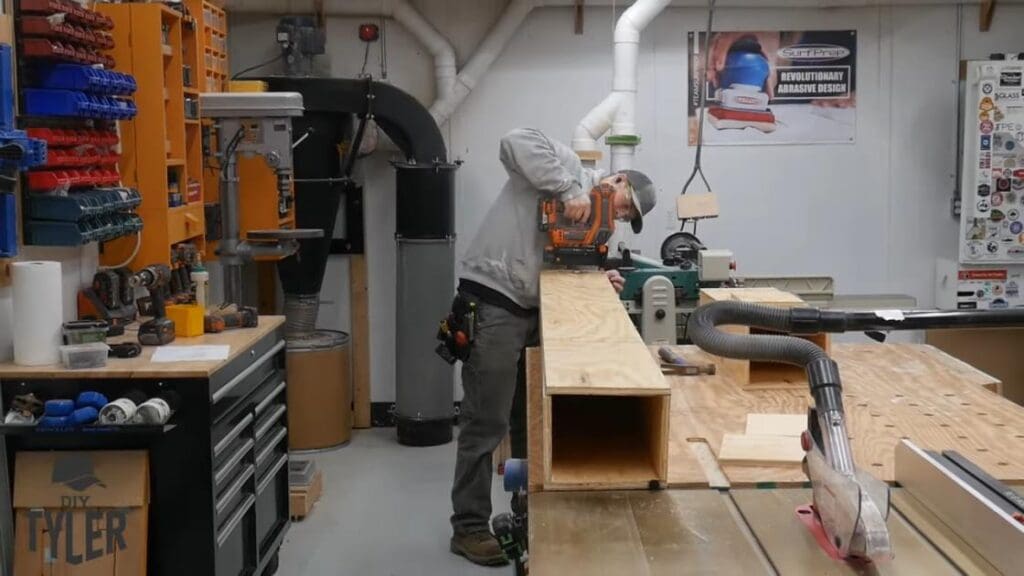 man fastening plywood pieces together for steam box