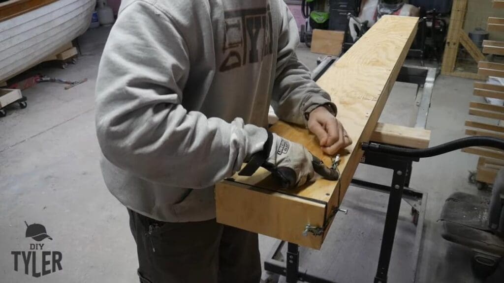 man tying steam box door shut
